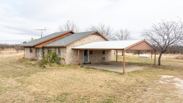 rear view of property with a lawn