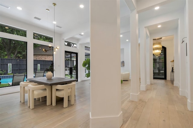 dining space featuring a chandelier and light hardwood / wood-style floors