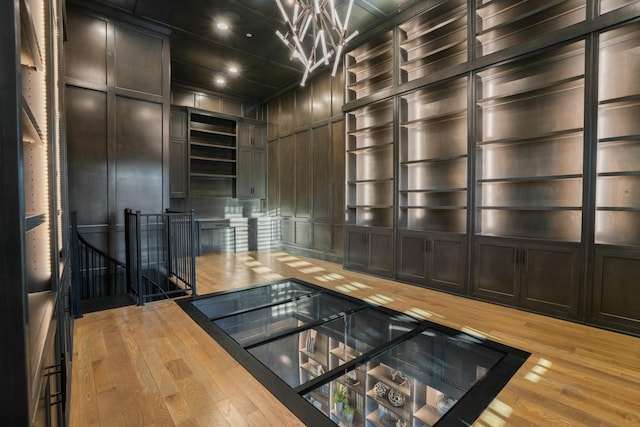 kitchen featuring wooden walls, butcher block countertops, and light hardwood / wood-style flooring