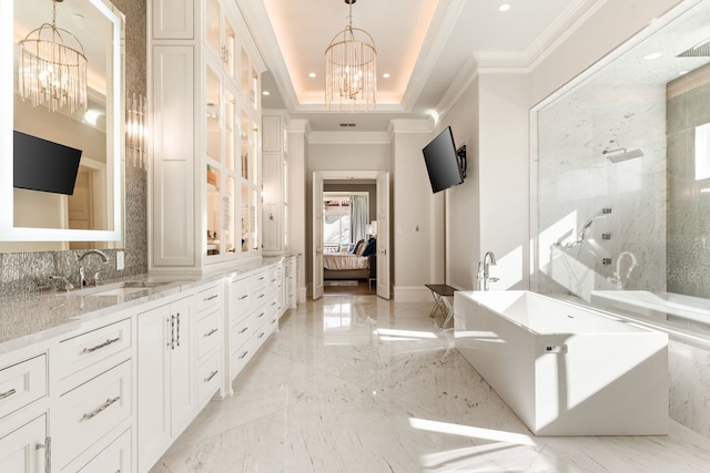 bathroom featuring crown molding, vanity, a chandelier, and a raised ceiling