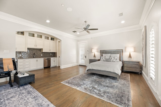 bedroom with dark hardwood / wood-style floors, crown molding, sink, and ceiling fan