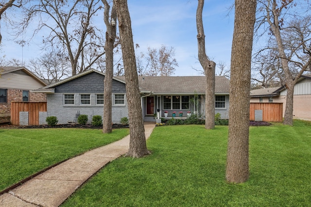 ranch-style home featuring a front yard