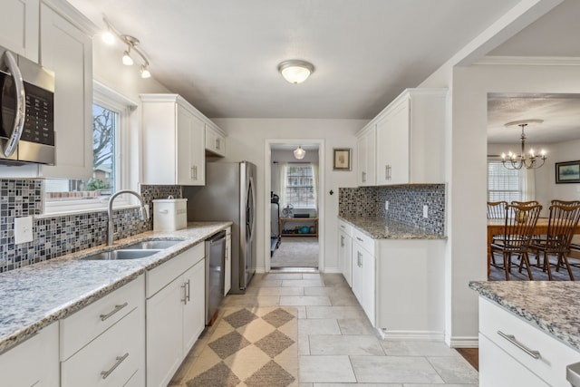 kitchen featuring sink, white cabinets, and stainless steel appliances