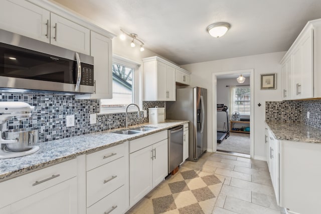 kitchen with white cabinetry, sink, and stainless steel appliances