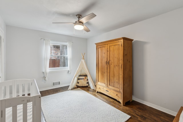 bedroom with dark hardwood / wood-style floors and ceiling fan