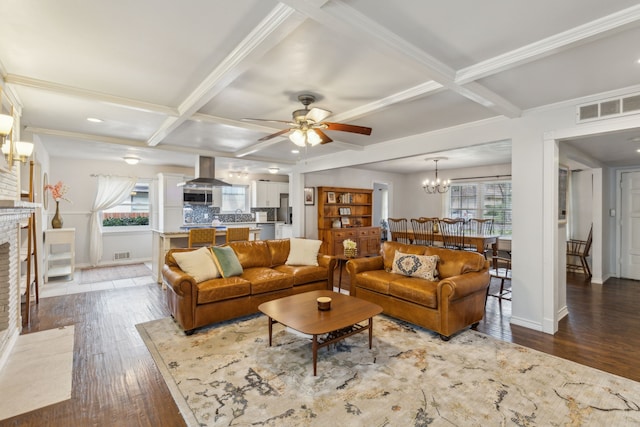 living room with a wealth of natural light, beamed ceiling, and coffered ceiling