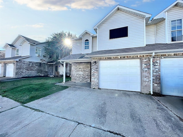 view of front of property featuring a garage and a front lawn