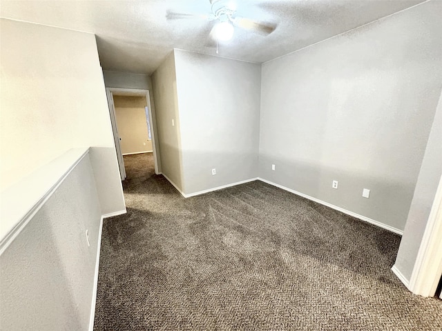 carpeted empty room with ceiling fan and a textured ceiling