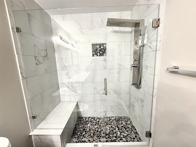 bathroom featuring a shower with shower door