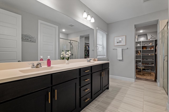 bathroom with walk in shower and vanity