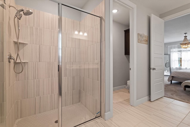 bathroom featuring toilet and an enclosed shower