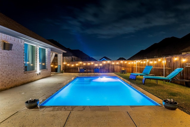 view of pool at twilight