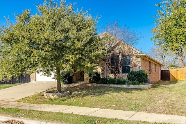 obstructed view of property with a front lawn and a garage