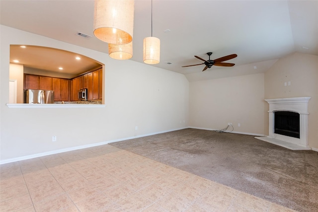 unfurnished living room with light colored carpet, ceiling fan, and lofted ceiling