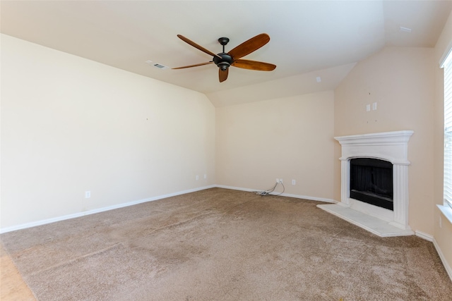 unfurnished living room featuring ceiling fan, light colored carpet, and vaulted ceiling