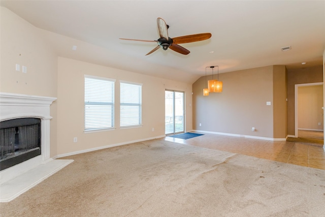 unfurnished living room featuring ceiling fan, lofted ceiling, and light carpet