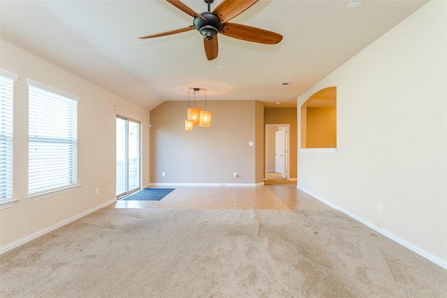 carpeted spare room featuring ceiling fan and vaulted ceiling