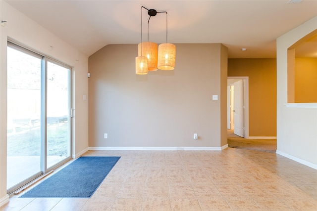 spare room featuring light tile patterned floors and vaulted ceiling