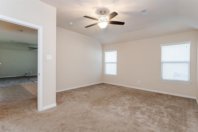 spare room featuring ceiling fan and light colored carpet