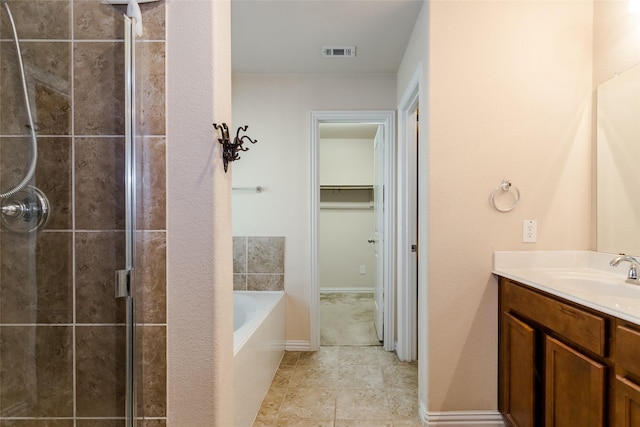 bathroom with vanity and separate shower and tub