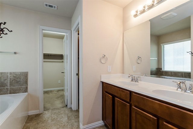 bathroom with vanity and a tub