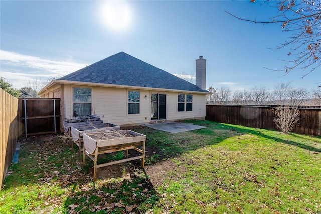 rear view of property with a patio area and a yard