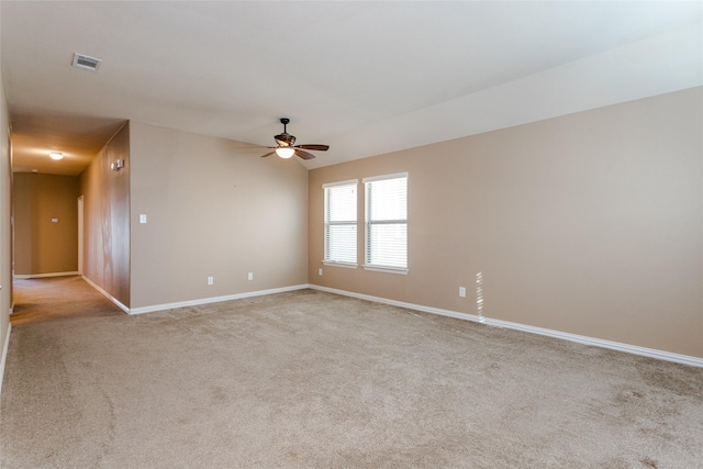 empty room with ceiling fan, lofted ceiling, and light carpet