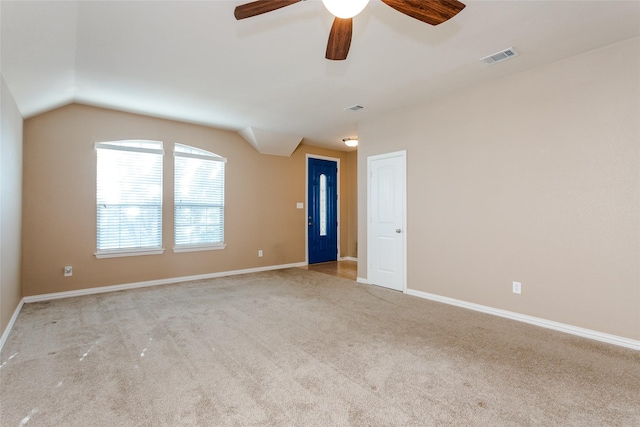 unfurnished room featuring ceiling fan, light carpet, and vaulted ceiling