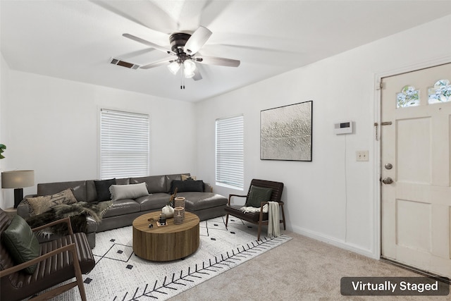 living room featuring ceiling fan and carpet floors