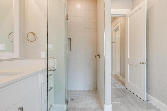 bathroom featuring vanity and an enclosed shower