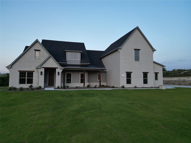 view of front of property featuring covered porch and a front yard