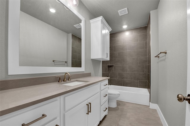 full bathroom featuring vanity, tiled shower / bath, a textured ceiling, and toilet