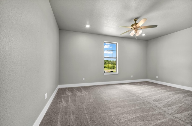 carpeted spare room with ceiling fan and a textured ceiling