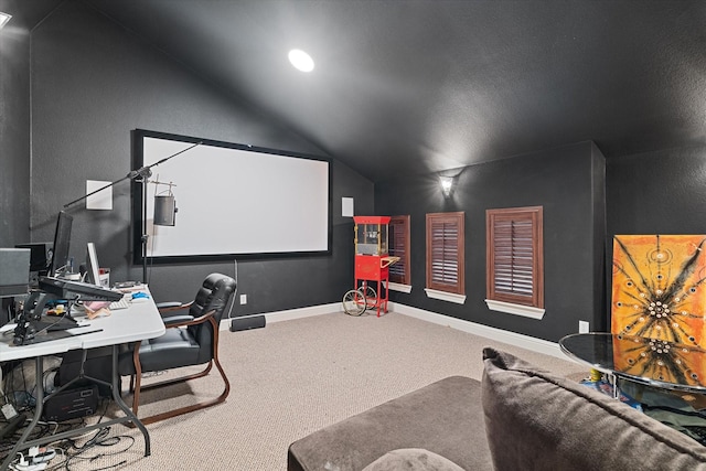 carpeted home theater featuring vaulted ceiling