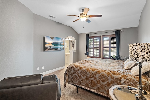 carpeted bedroom with ensuite bath, ceiling fan, and lofted ceiling