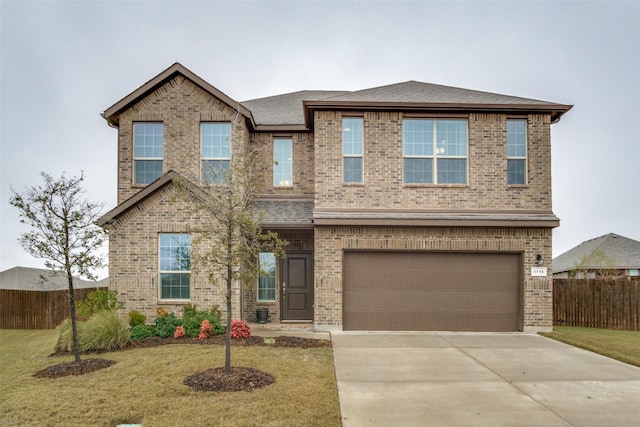 view of front facade featuring a garage and a front yard