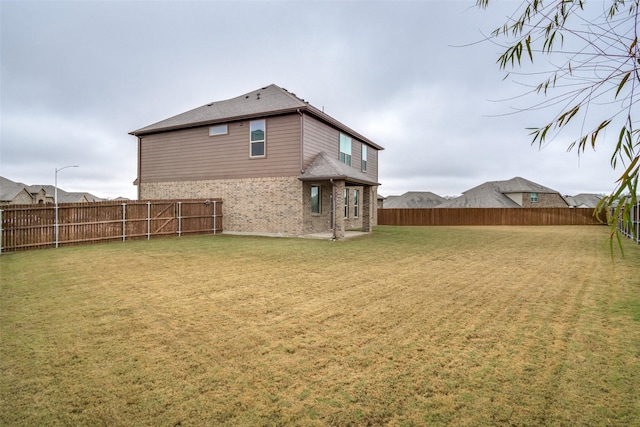 rear view of property with a lawn