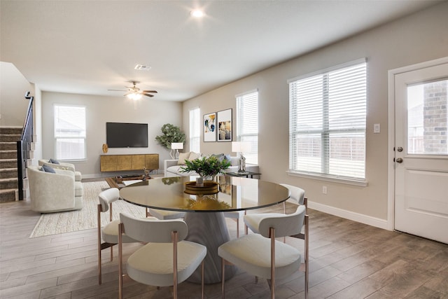 dining space featuring hardwood / wood-style flooring and ceiling fan