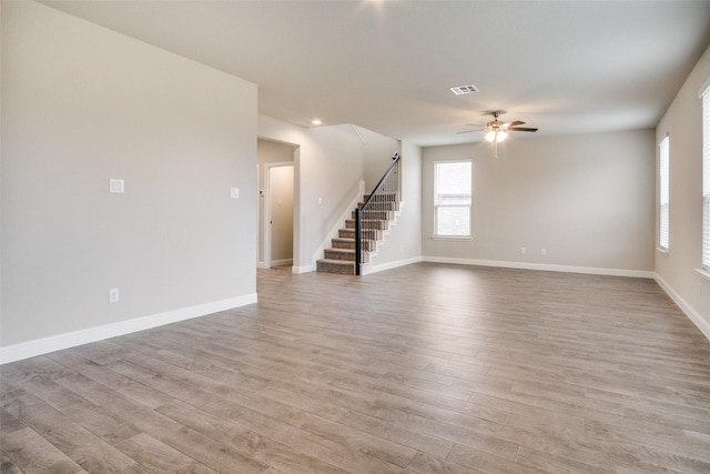 empty room featuring light wood-type flooring and ceiling fan