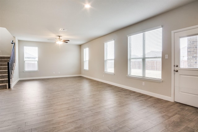 unfurnished living room featuring hardwood / wood-style floors and plenty of natural light