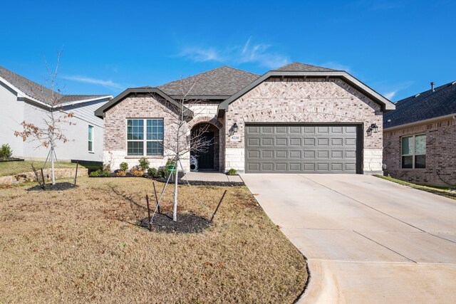 view of front of house featuring a garage and a front lawn