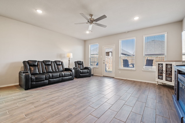 living room featuring light hardwood / wood-style floors and ceiling fan