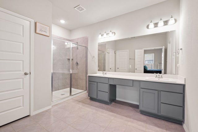 bathroom with tile patterned floors, vanity, and an enclosed shower