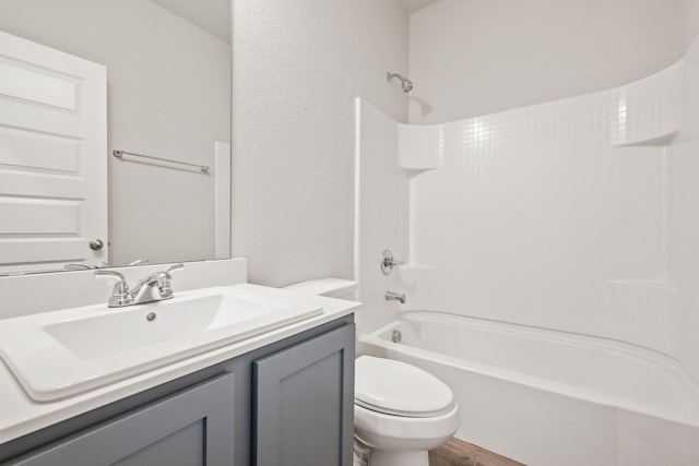 full bathroom with shower / tub combination, vanity, toilet, and wood-type flooring