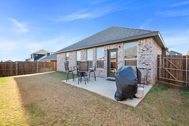 back of house featuring a lawn and a patio