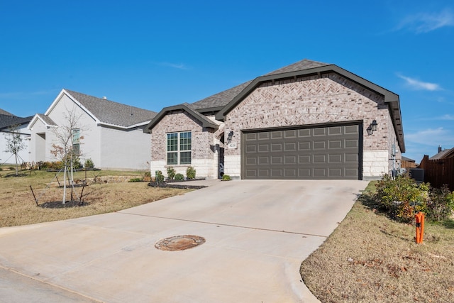 view of front of property with a front yard and a garage