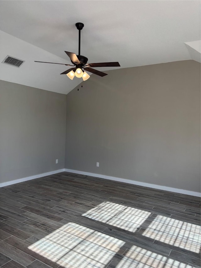 empty room with ceiling fan, dark hardwood / wood-style flooring, and lofted ceiling