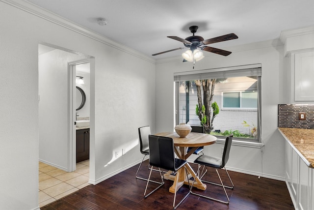 dining room with crown molding, ceiling fan, and light hardwood / wood-style flooring