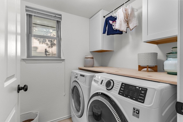 laundry room with cabinets and washing machine and clothes dryer