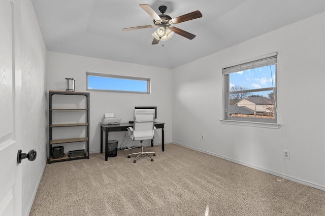 carpeted office space featuring ceiling fan